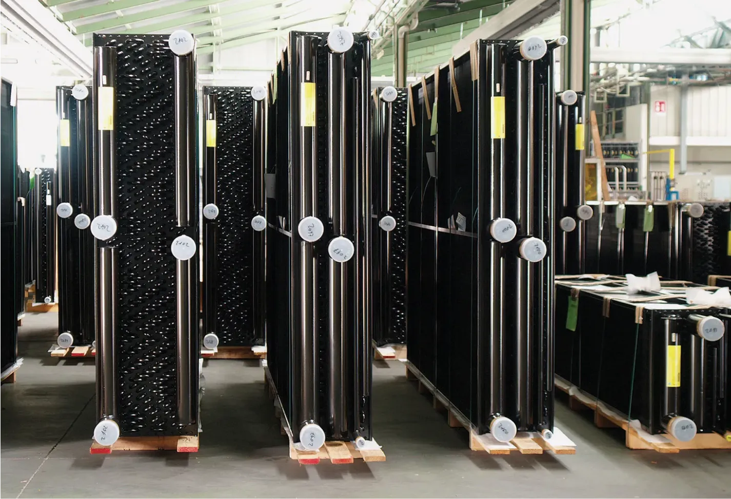 Industrial heat exchangers ready for shipment inside a manufacturing facility