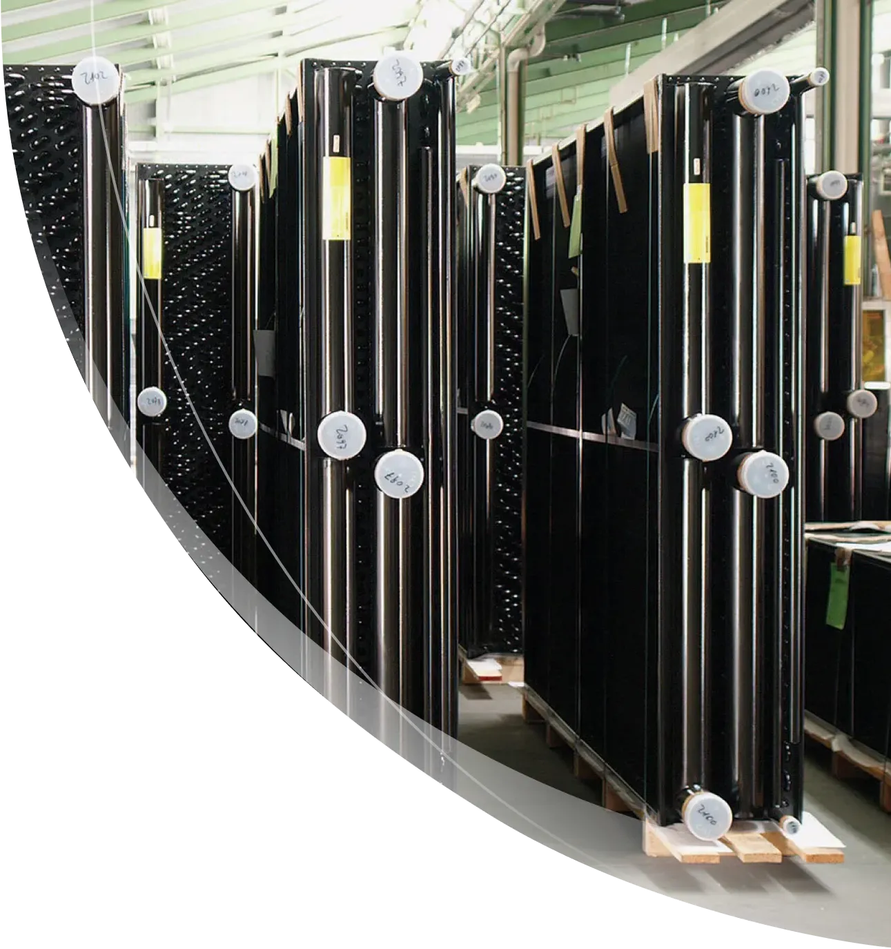 Industrial glass panels in vertical storage racks inside a modern glass manufacturing facility