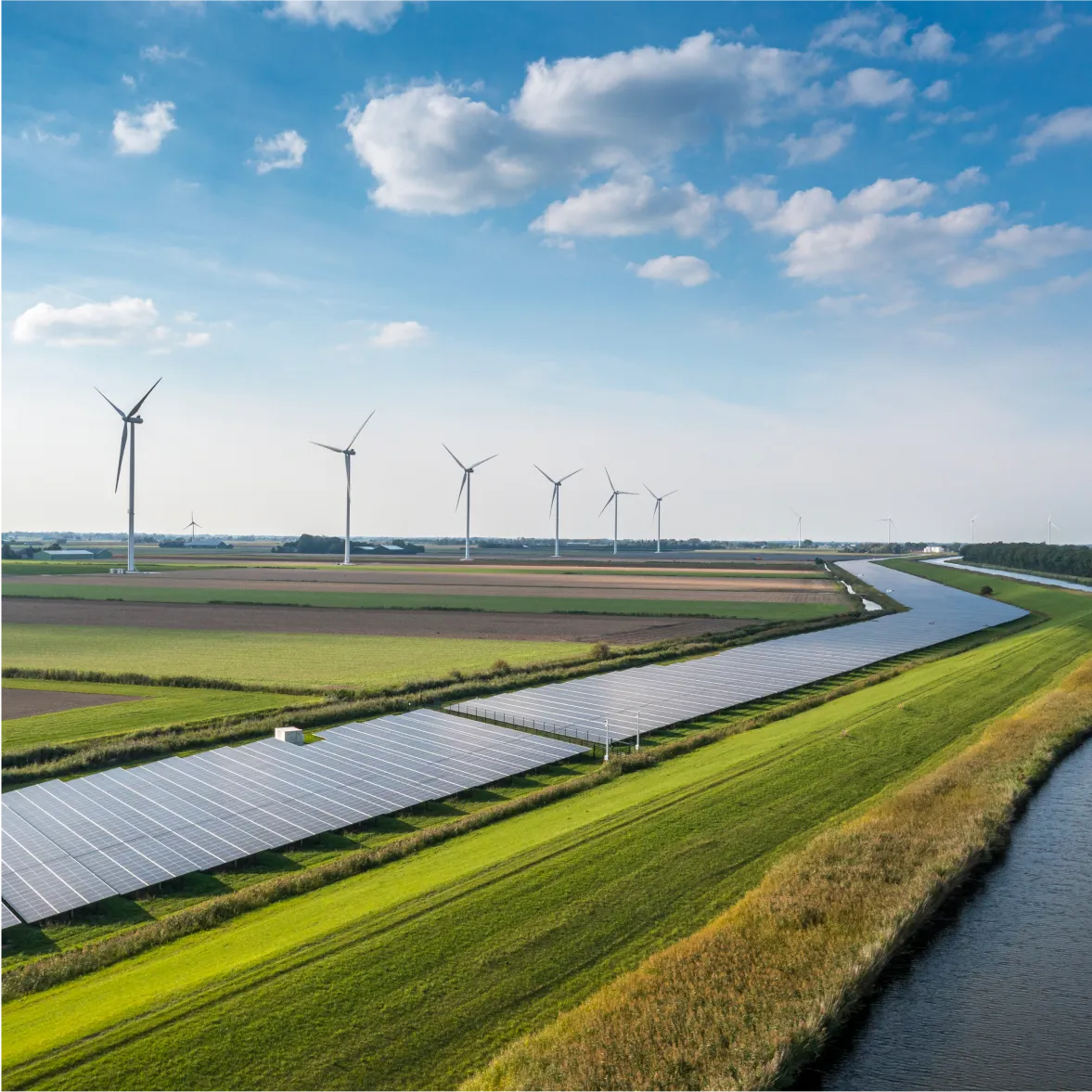 Renewable energy landscape with wind turbines and solar panels on agricultural land