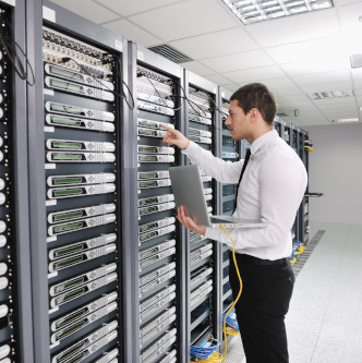 young engeneer in datacenter server room